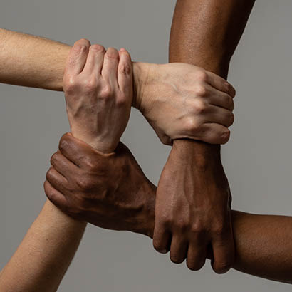 hands of people of different skin color intertwined